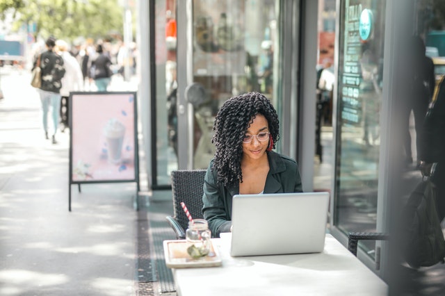 Woman working in a cafe using public WIFi