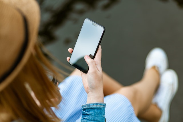 Person reading smishing text message on mobile