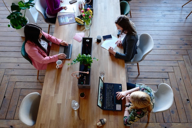 People sitting around a coworking desk